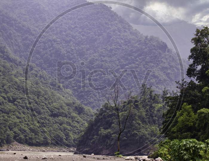 Top Of The Mountain Covered With Cloud And River In Rishikesh In Indian Himalayas Terrain