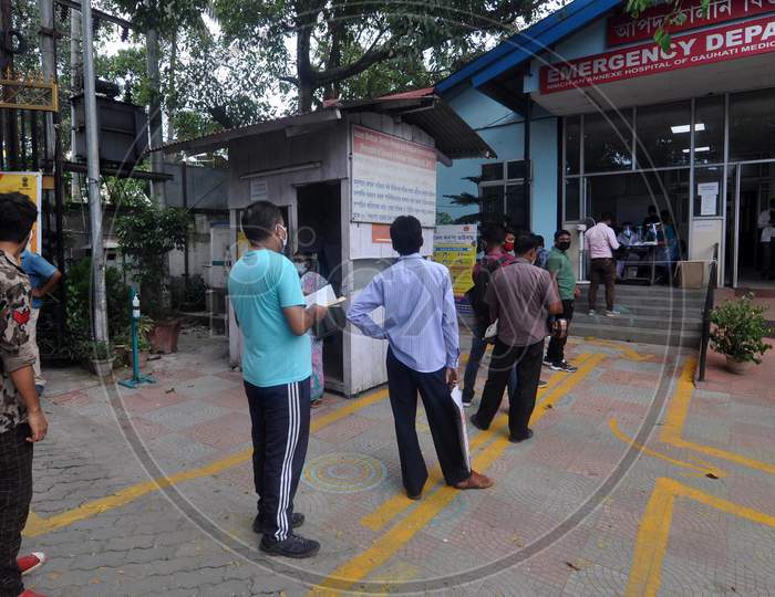 People wait in a queue to get tested for Coronavirus outside a government hospital in Guwahati, Assam on July 06, 2020.