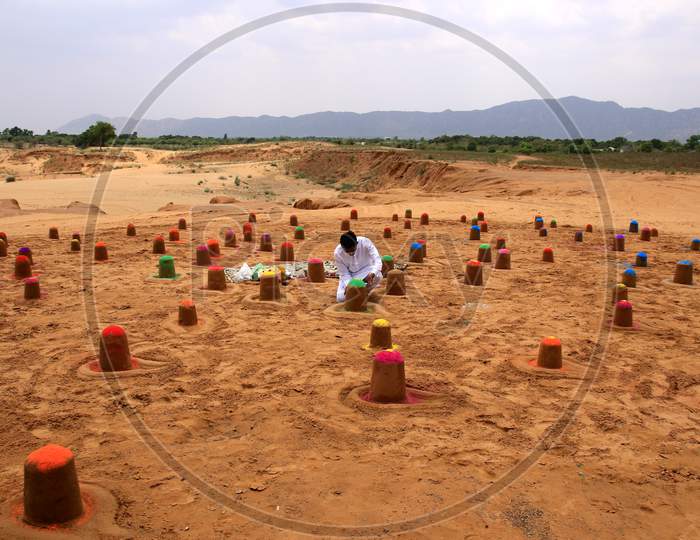 Indian sand artist Ajay Rawat creates 108 shivalings on the first Monday of 'Sawan'month in Pushkar, Rajasthan on July 06, 2020.
