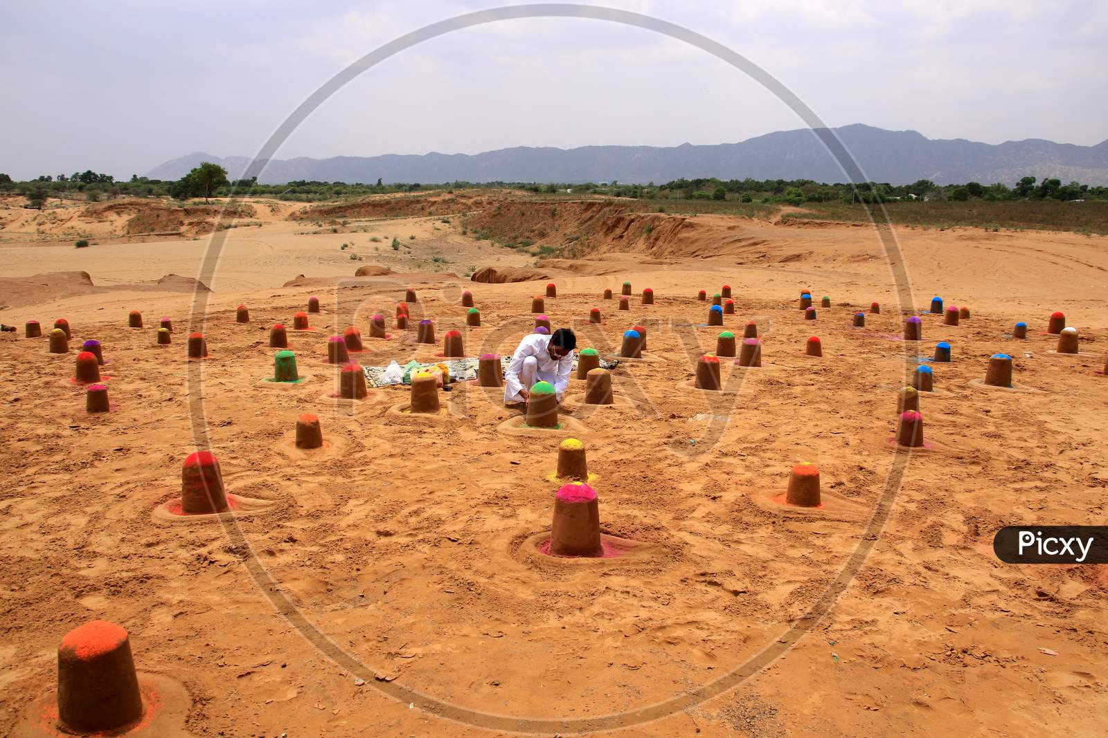 Indian sand artist Ajay Rawat creates 108 shivalings on the first Monday of 'Sawan'month in Pushakar, Rajasthan on July 06, 2020.