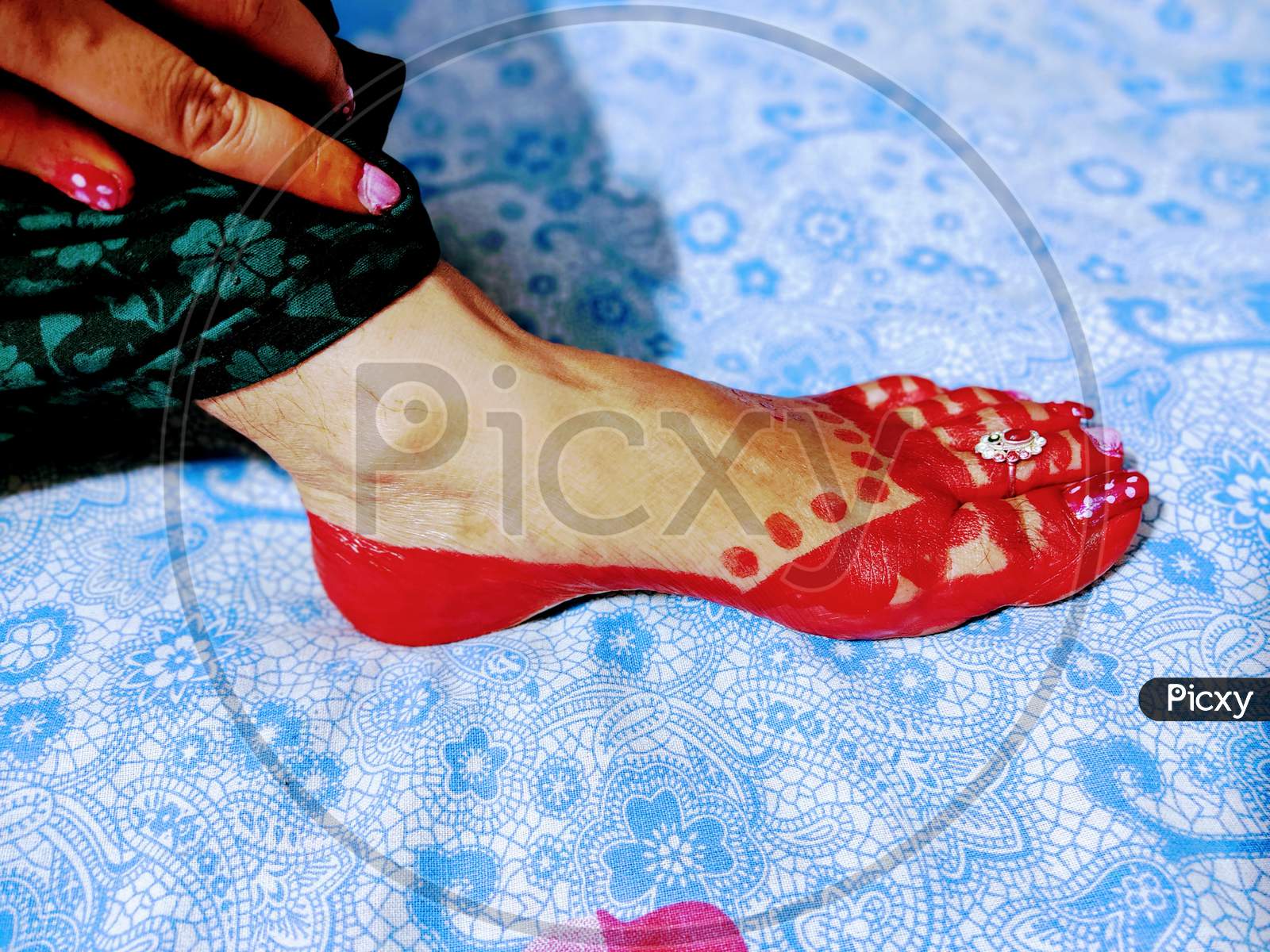 Red Aalta Work by Indian Lady on her foot