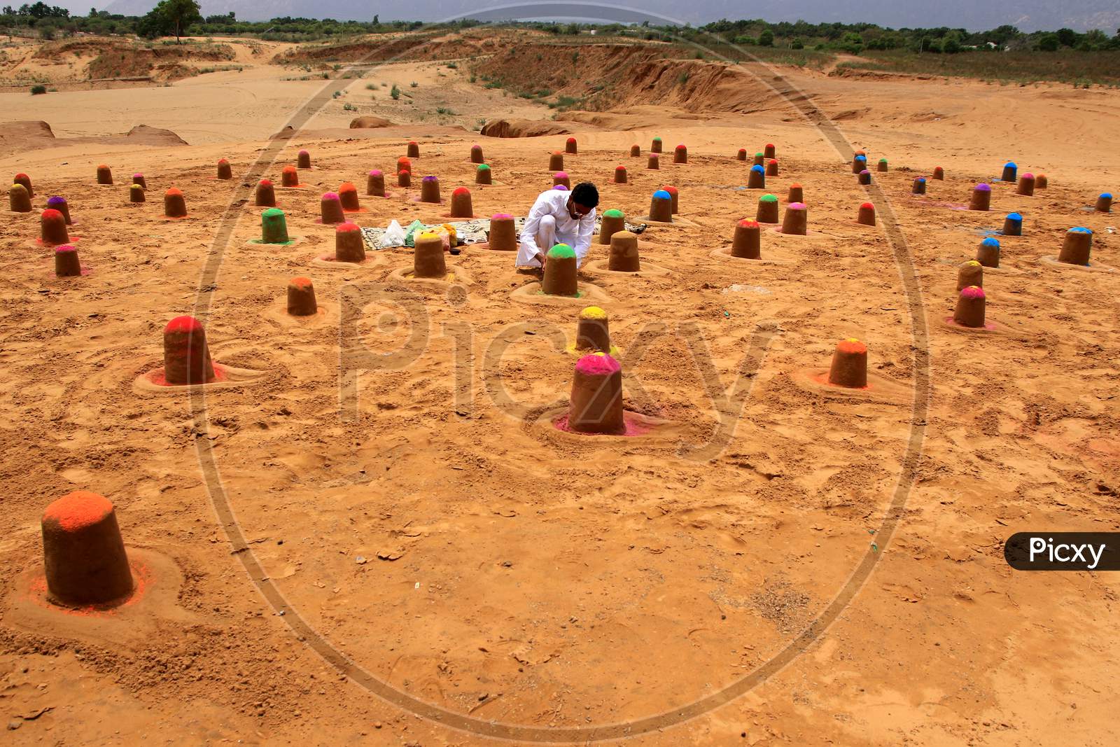 Indian sand artist Ajay Rawat creates 108 shivalings on the first monday of 'Sawan'month in Pushakar, Rajasthan on July 06, 2020.