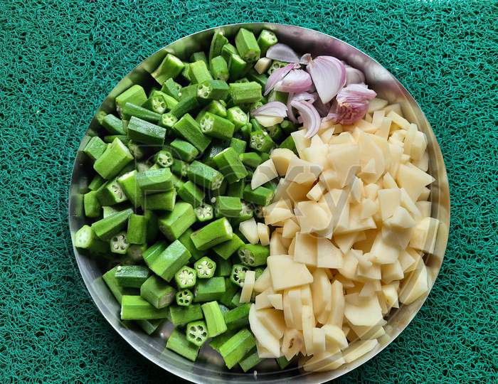 Fresh green ladyfingers potatoes chips and chopped onion