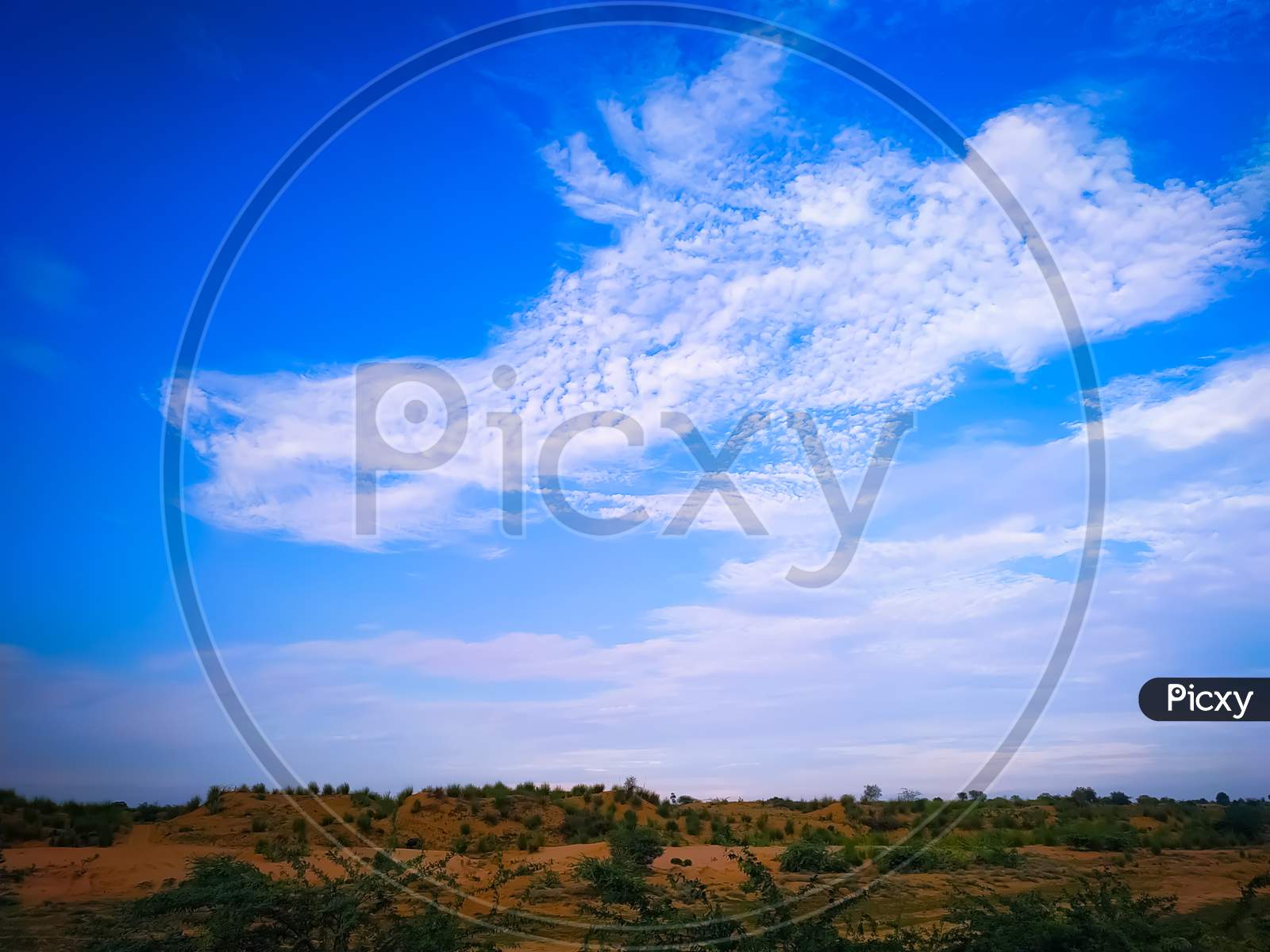 Landscape With Field Backdrop On Blue Sky