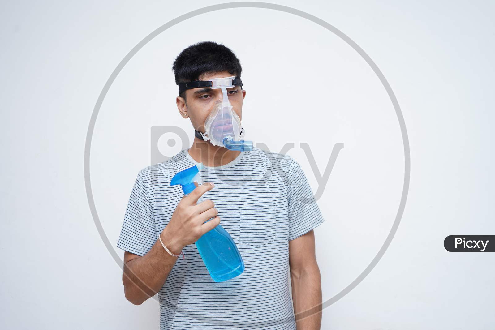 Young Asian Teen Boy Using Sanitizer While Wearing Oxygen Mask.