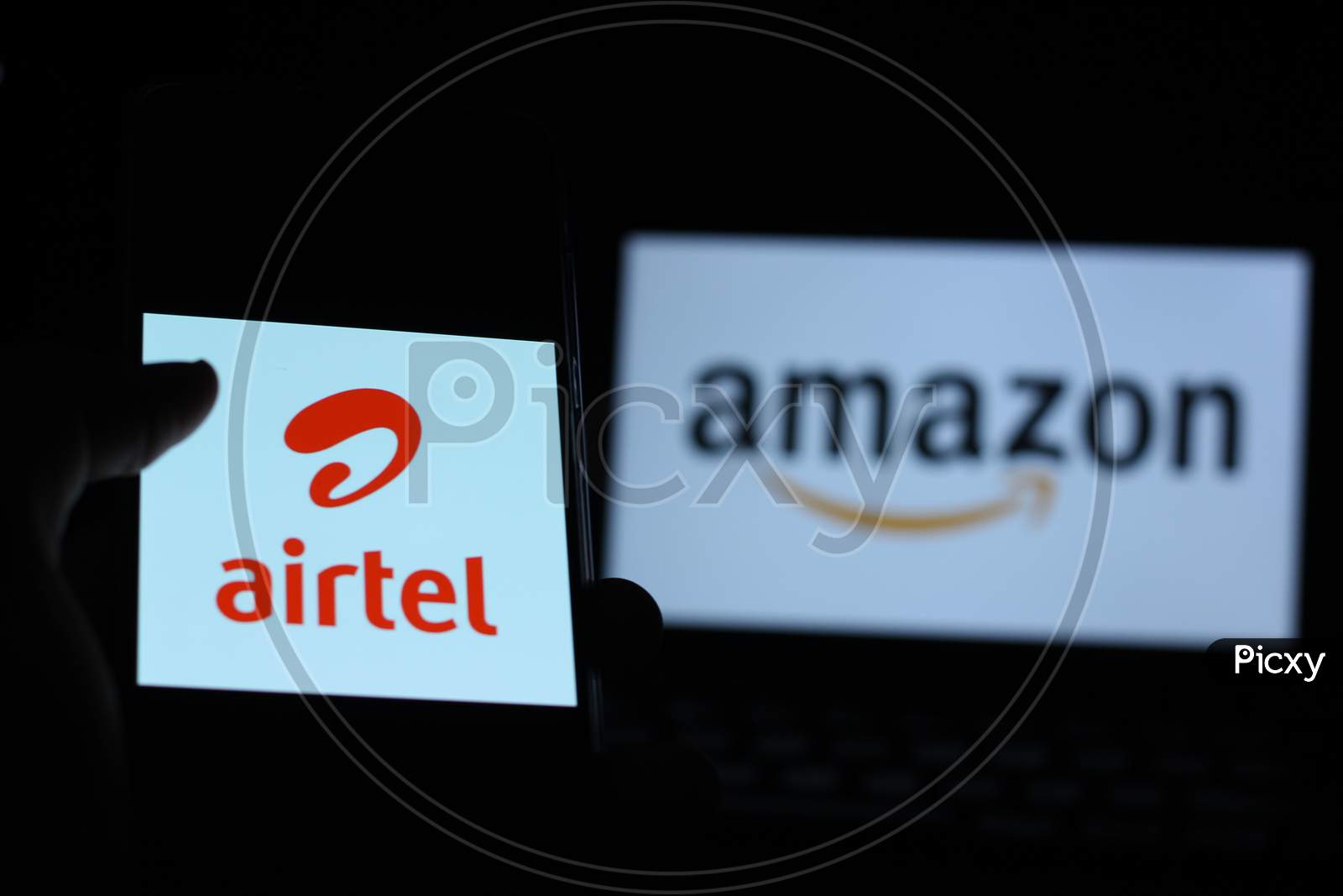 Bharti Airtel Logo with Amazon logo on background