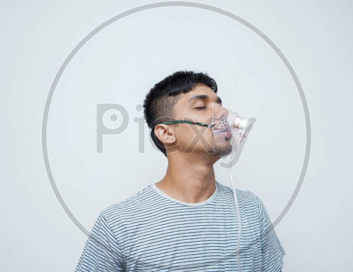 Young Handsome Asian Teen Boy Wearing An Oxygen Mask, Stop Corona Virus And Stop Pollution Concept.