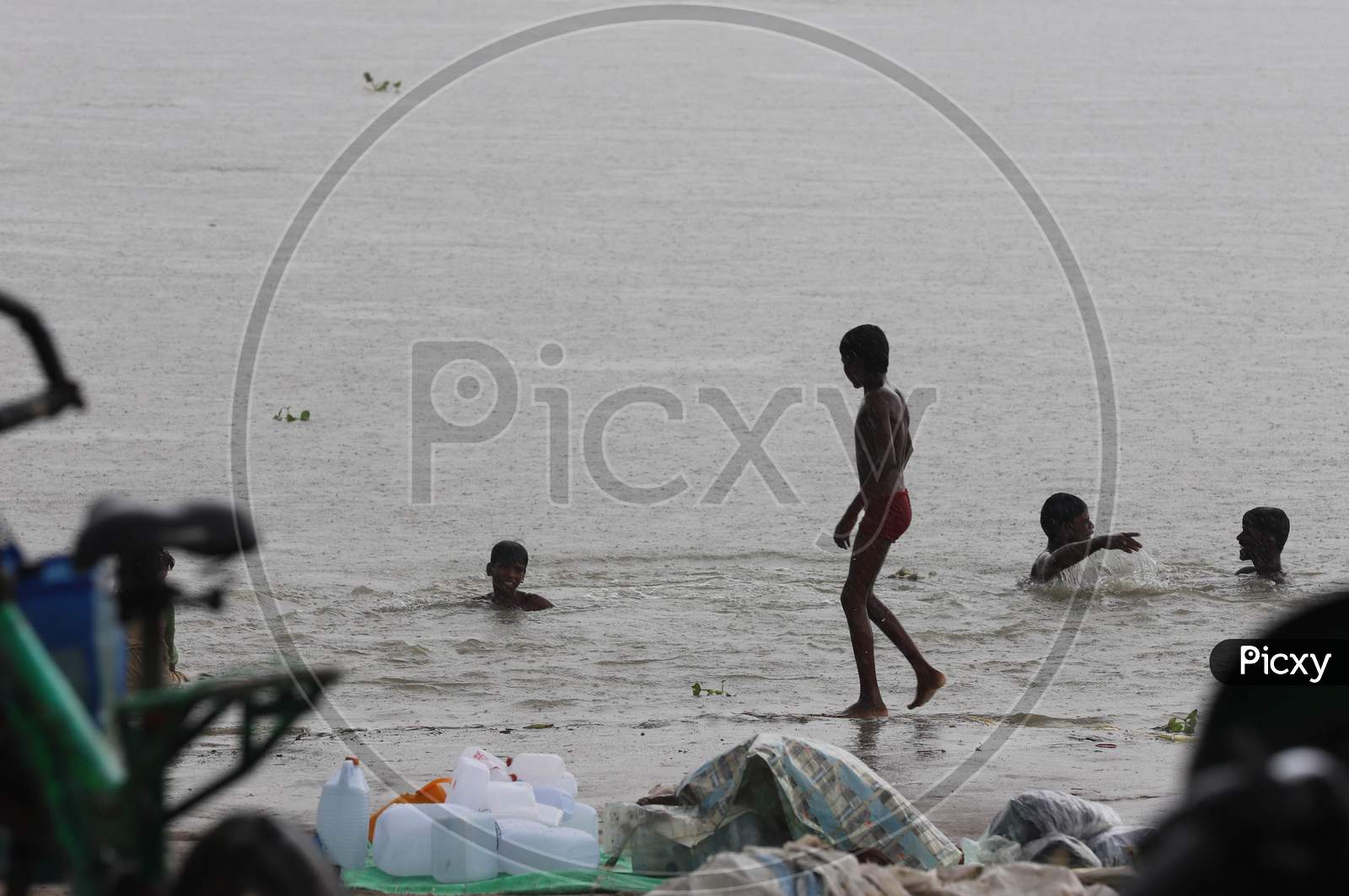 Kids take a dip in River Ganga which saw an increase in its water level due to heavy rainfall in Prayagraj, Uttar Pradesh on July 07, 2020