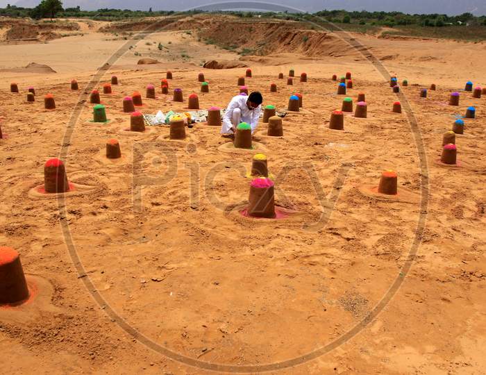 Indian sand artist Ajay Rawat creates 108 shivalings on the first monday of 'Sawan'month in Pushakar, Rajasthan on July 06, 2020.