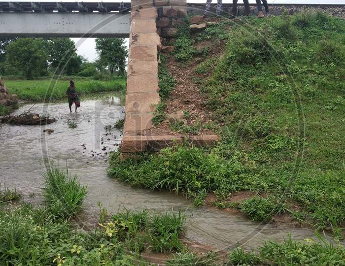 Old Railway Bridge In Countryside Area With Some People