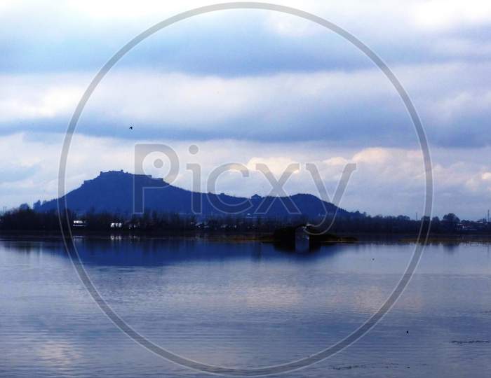 a view of dal lake on a misty morning