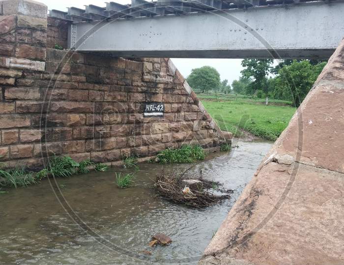 Railway Bridge Made Of Stones With Stream Water