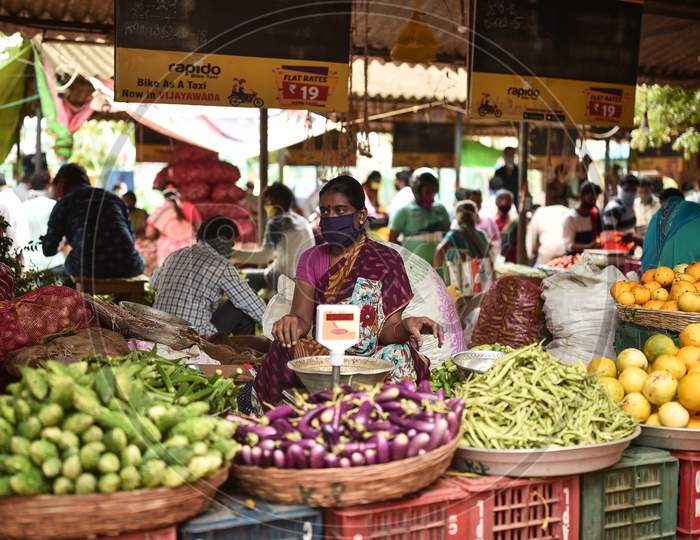 A vendor waits for customers at a vegetable market in Vijayawada.