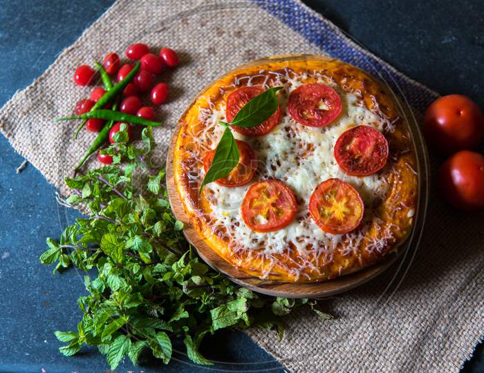 Pizza With Mint Leaves And Cherries In Arrangement