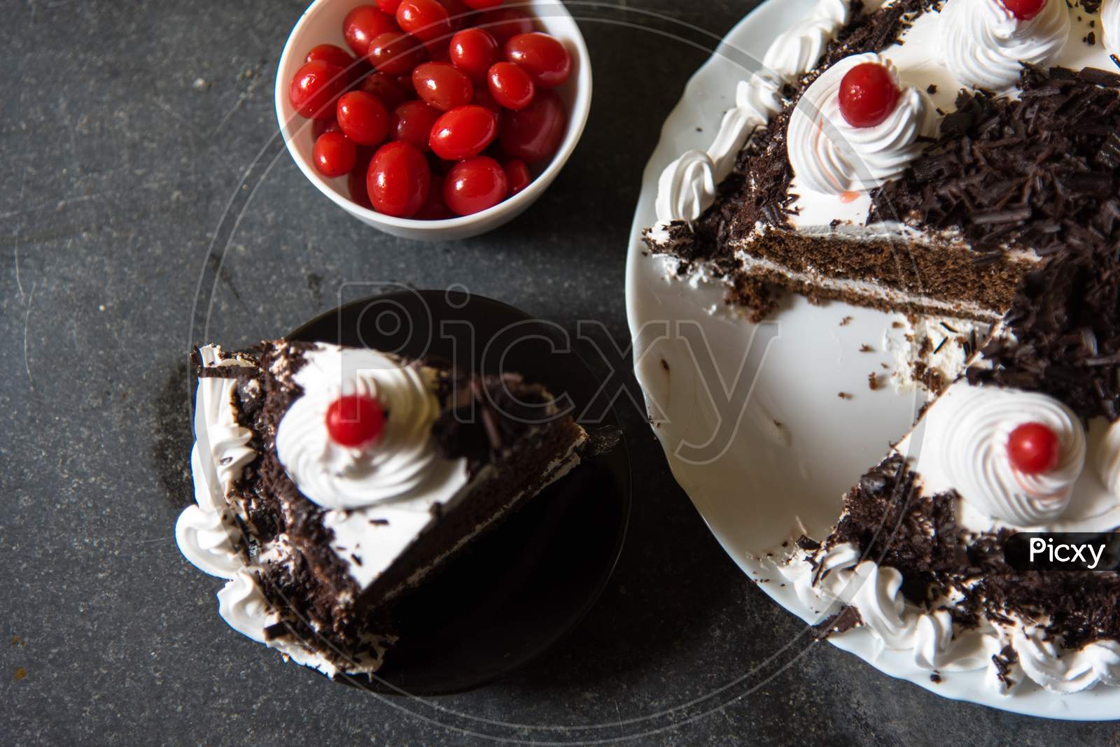 A Slice Of Black Forest Cake And Cherries