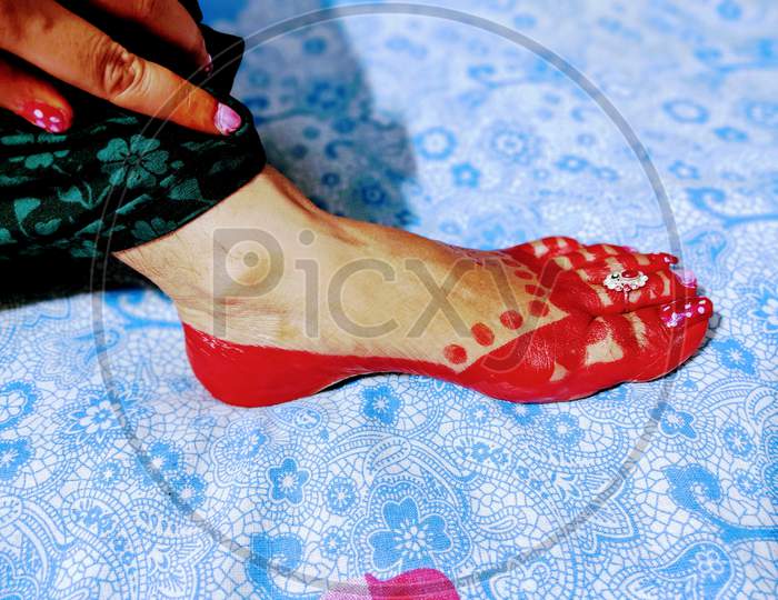 Red Aalta Work by Indian Lady on her foot