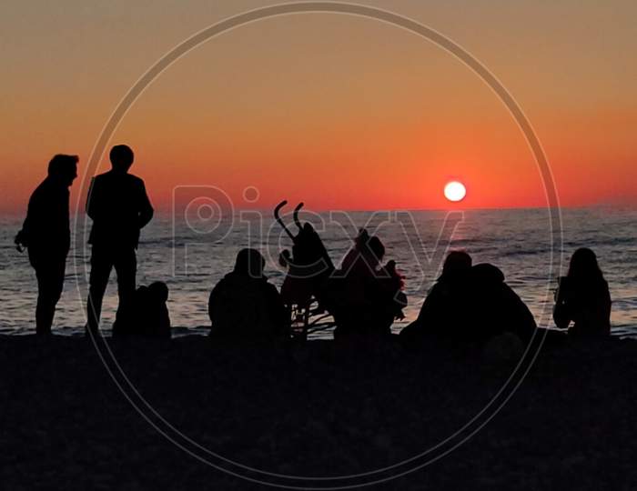 Family chilling at beach silhouette photography