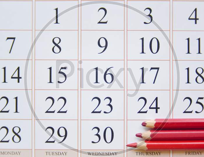 Calendar And Three Red Pencils Near The Last Date