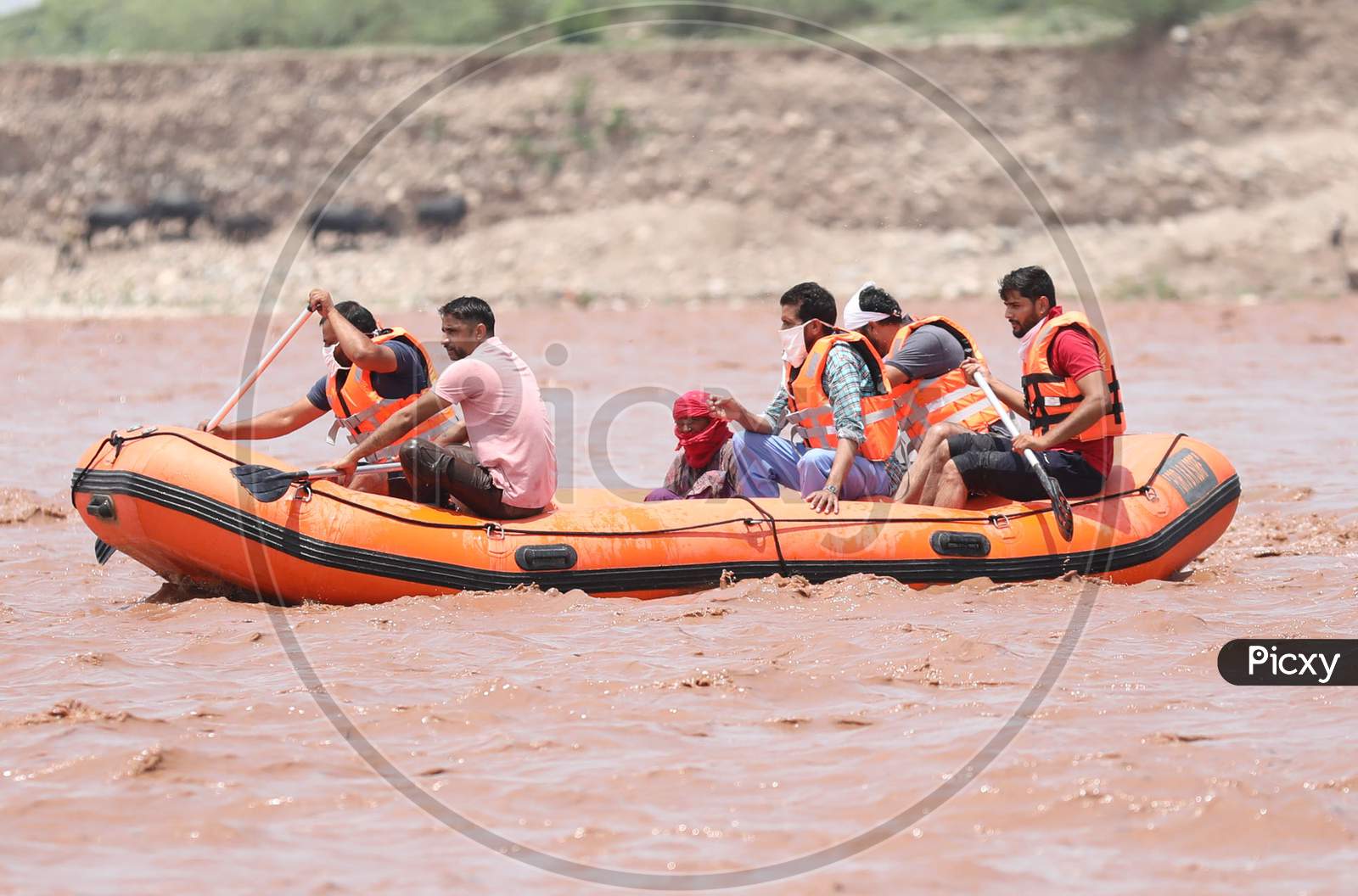SDRF personnel rescue a woman who was caught in the Tawi River as water levels rose due to heavy rainfall on July 08, 2020 in Jammu