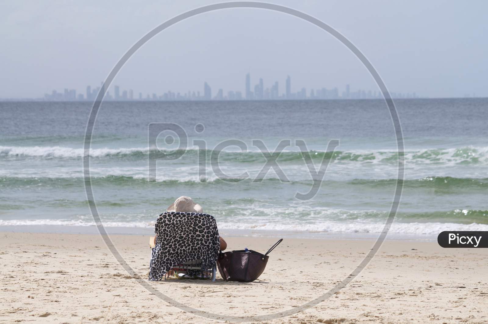 Woman Sitting On A Beach Chair In Coolangatta Beach