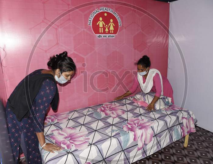Worker prepares a bed at a quarantine centre