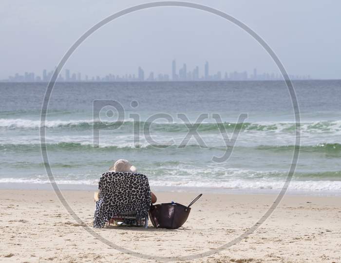 Woman Sitting On A Beach Chair In Coolangatta Beach