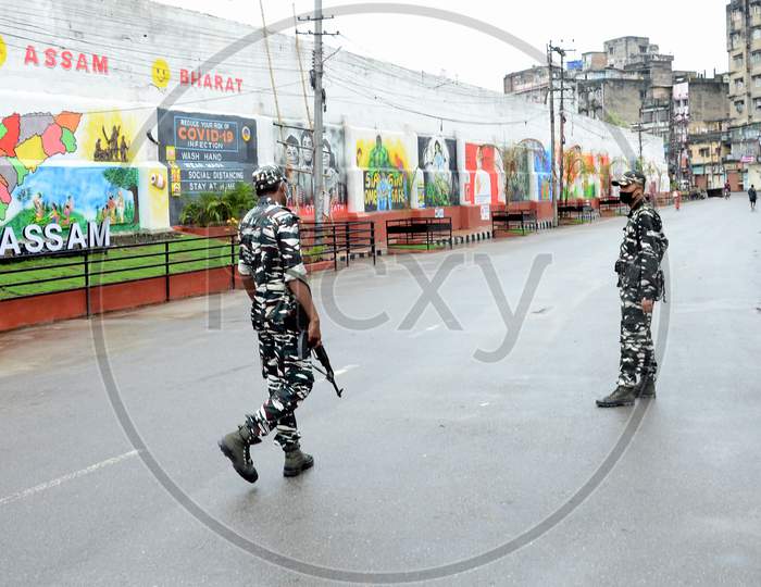 Security personnel patrol at Fancy Bazar