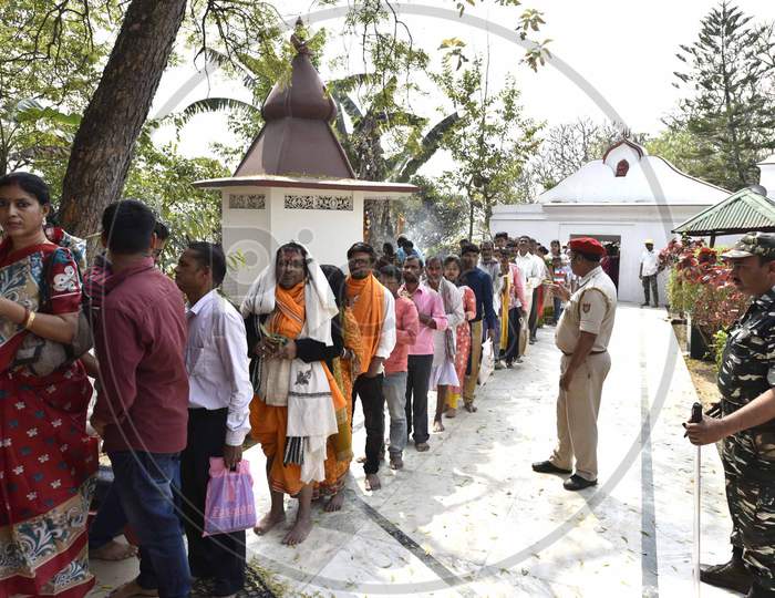 Devotees stand in a queue