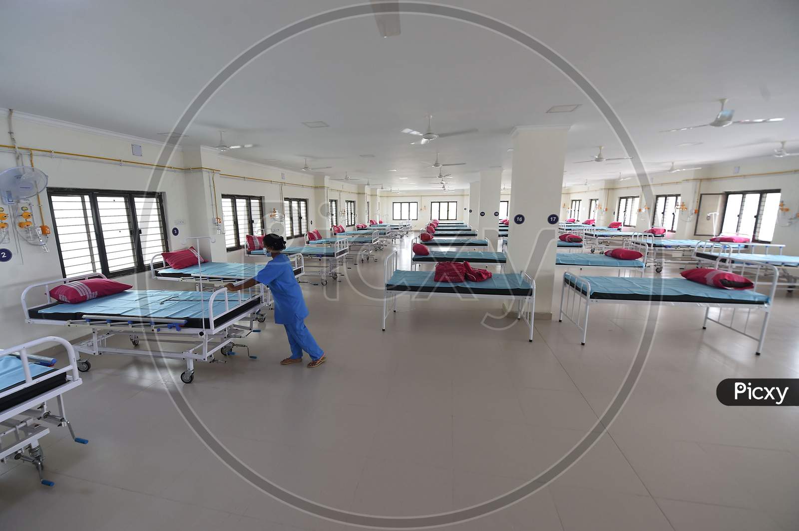 Health care worker arranges beds to convert a building which belonged to the National Institute of Ageing into a dedicated Covid-19 Care Centre in Chennai, Tamil Nadu on July 07, 2020