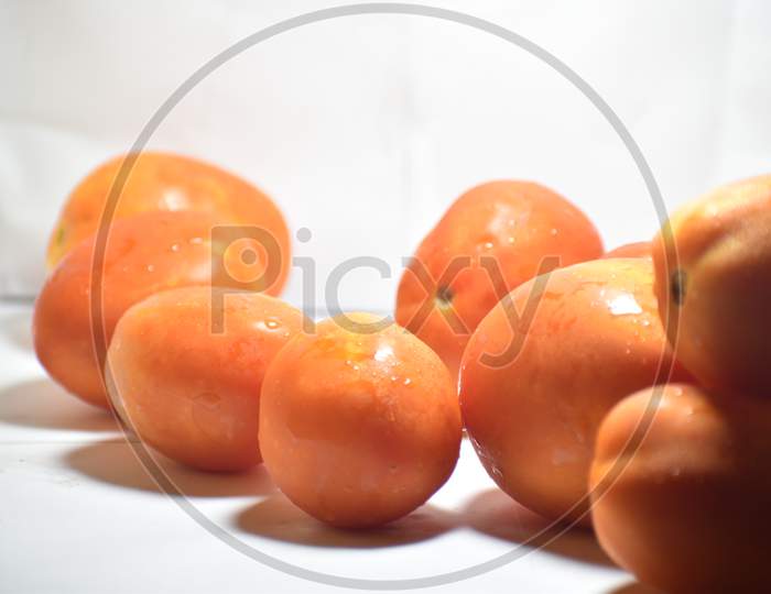 Tomatoes isolated on white. Tomato with drops. Full depth of field.