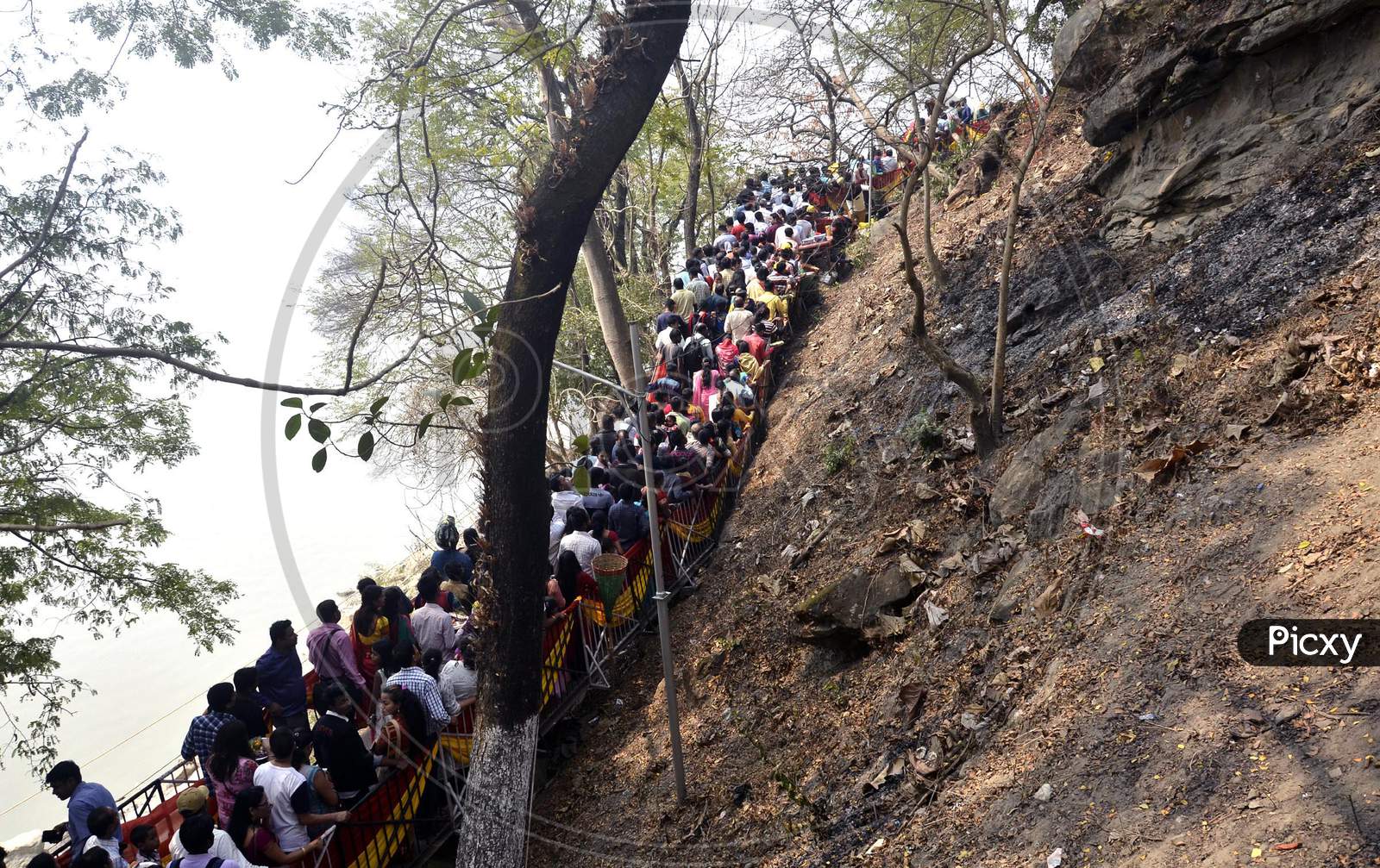 Devotees stand in a queue