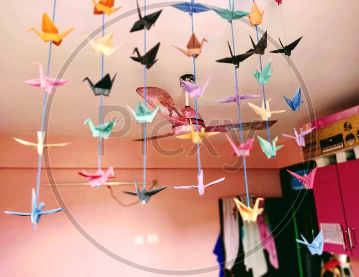 Ceiling Fan designed for kids room surrounded by bird toy made by colored paper