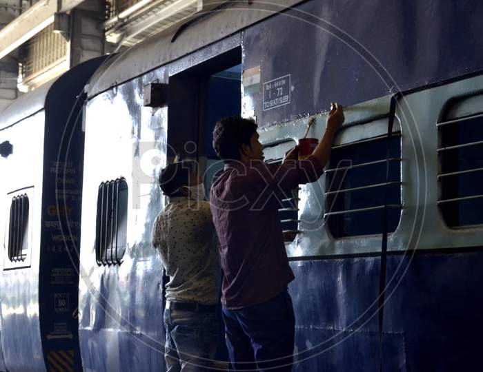 An Indian railway employee works to convert a train coach into an isolation for COVID-19 patients