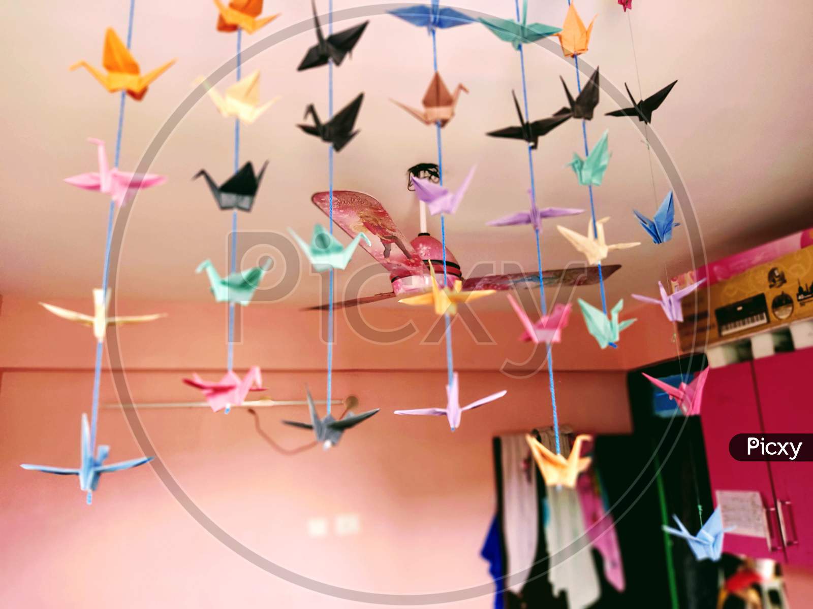 Ceiling Fan designed for kids room surrounded by bird toy made by colored paper