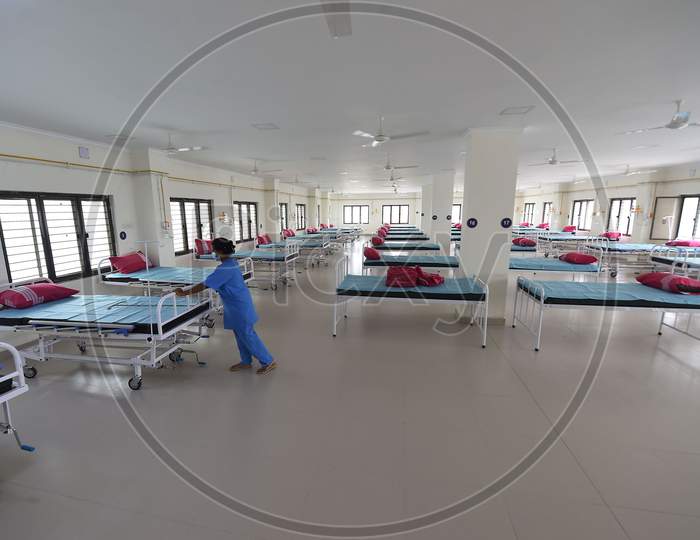 Health care worker arranges beds to convert a building which belonged to the National Institute of Ageing into a dedicated Covid-19 Care Centre in Chennai, Tamil Nadu on July 07, 2020