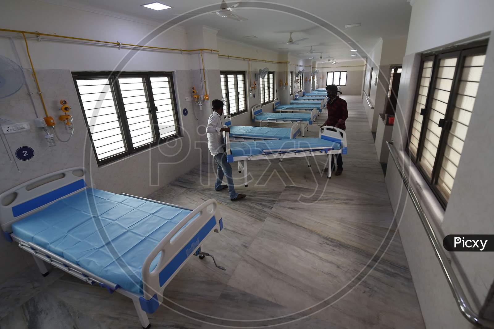 Health workers arrange beds to convert a building which belonged to the National Institute of Ageing into a dedicated Covid-19 Care Centre in Chennai, TamilNadu on July 07, 2020