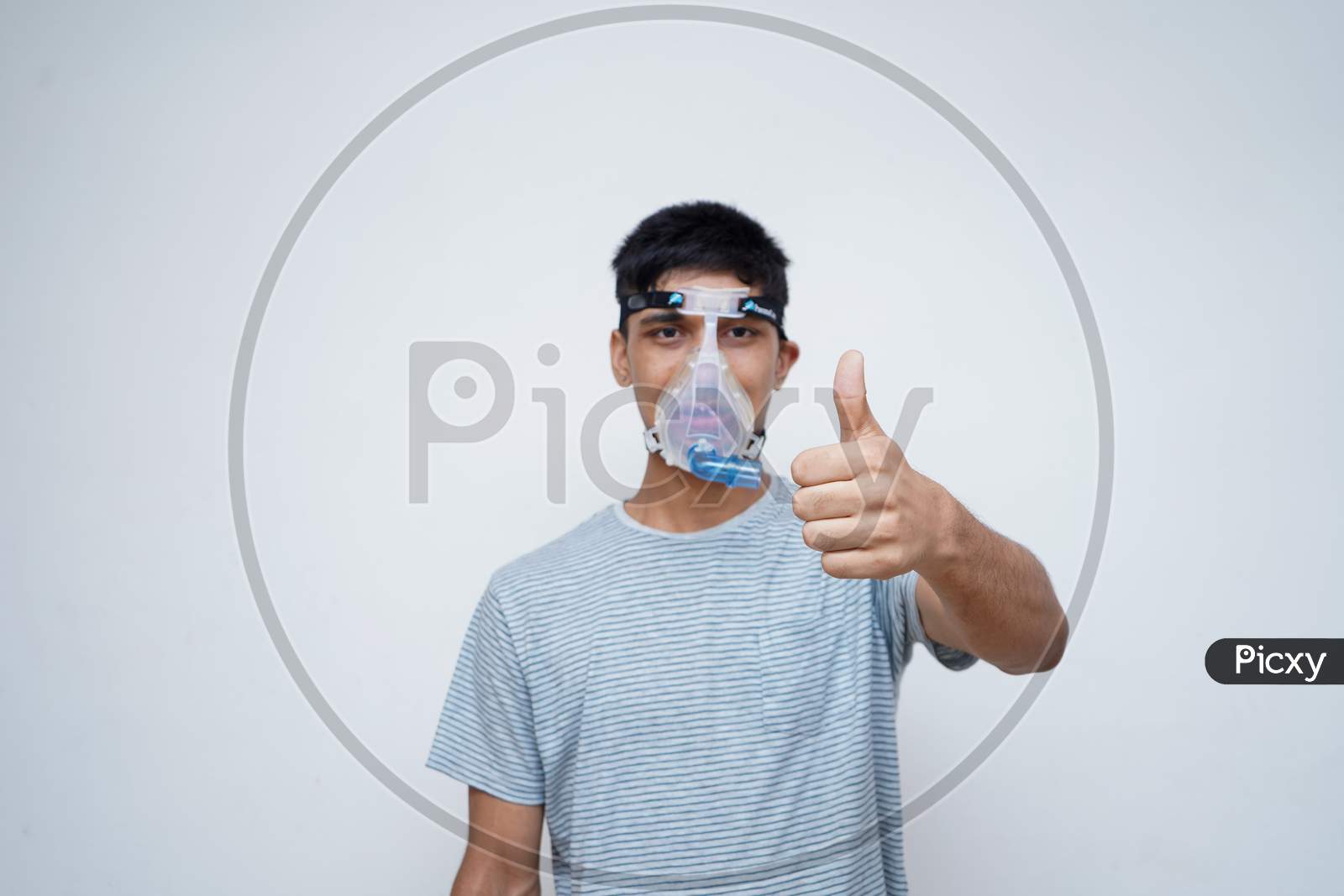 Young Handsome Asian Teen Boy Wearing An Oxygen Mask, Showing Thumbs Up In The Camera.Stop Corona Virus And Stop Pollution Concept.