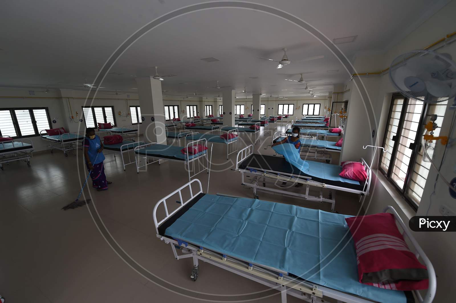 Health care workers arrange beds to convert a building which belonged to the National Institute of Ageing into a dedicated Covid-19 Care Centre in Chennai, Tamil Nadu on July 07, 2020