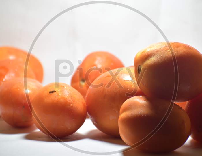 Tomatoes isolated on white. Tomato with drops. Full depth of field.