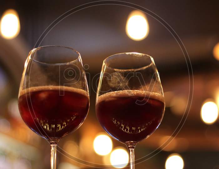 Two Goblets Filled With Red Wine With Fingerprints On Them.