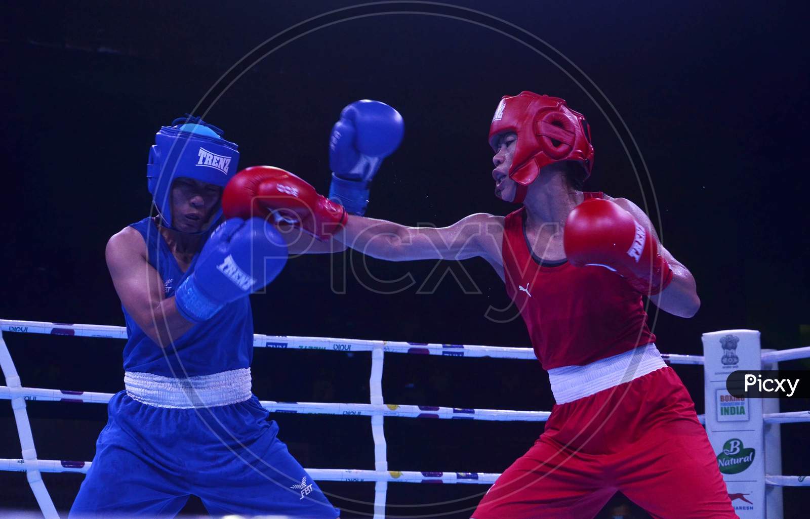 India's Boxer Mc Mary Kom (Red) action against Nepal Boxer Mala Rai(Blue)