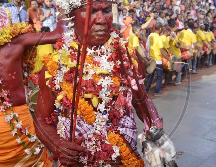 Hindu priest dances as he carries a sacrificial pair of pigeons in a procession during the three-day long Deodhani festival,