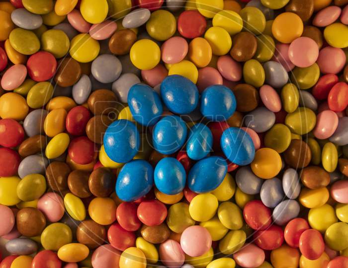 Background of multicolored chocolate balls with a depth of field view