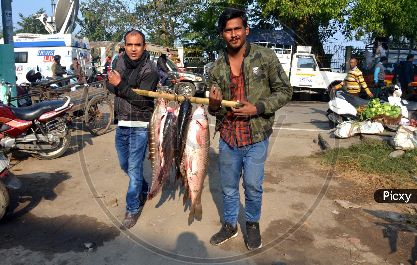 People buying different types of fishes at a local fish market on the occasion of Magh Bihu
