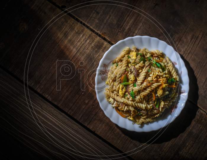 pasta with tomato sauce and vegetables in bowl. Top view. Flat lay