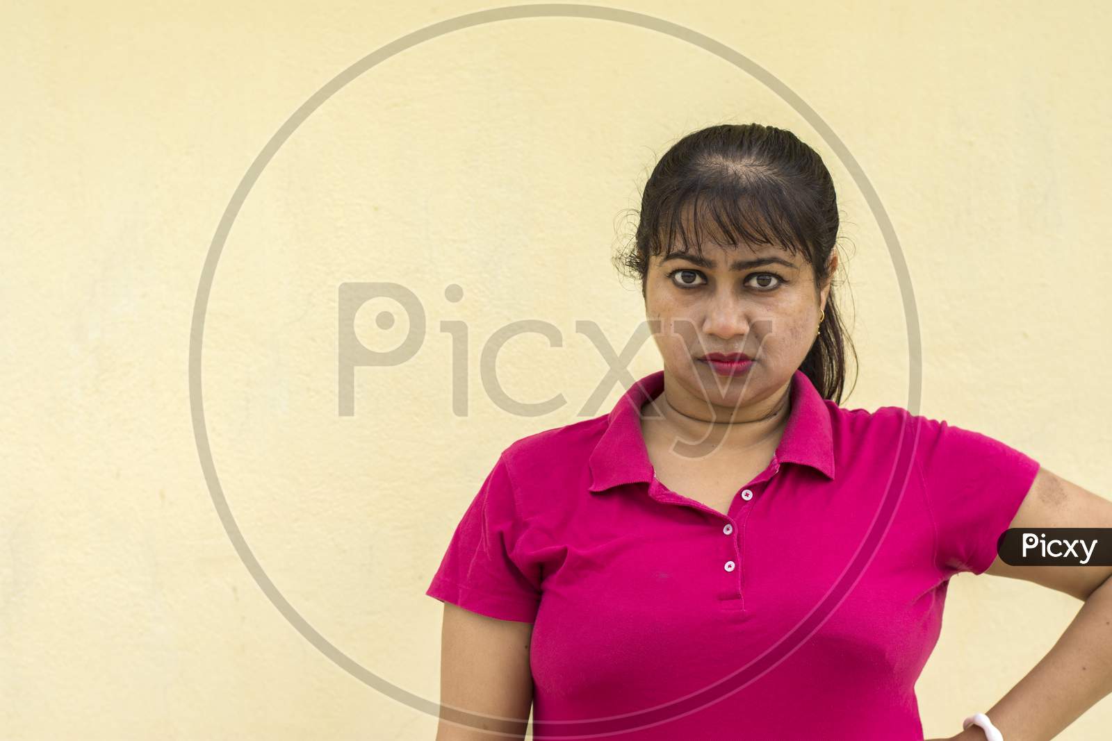 Indian Female Model Looking Straight Angry Face In Yellow Background With Copy Space For Text