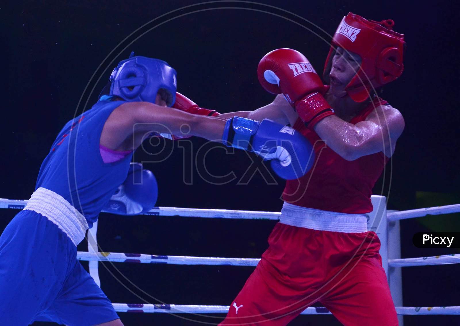 India's Boxer Mc Mary Kom (Red) action against Nepal Boxer Mala Rai(Blue)