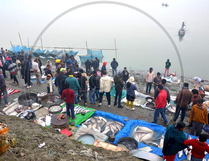 People throng in Fish Market on the bank of river Brahmaputra to buy fishes