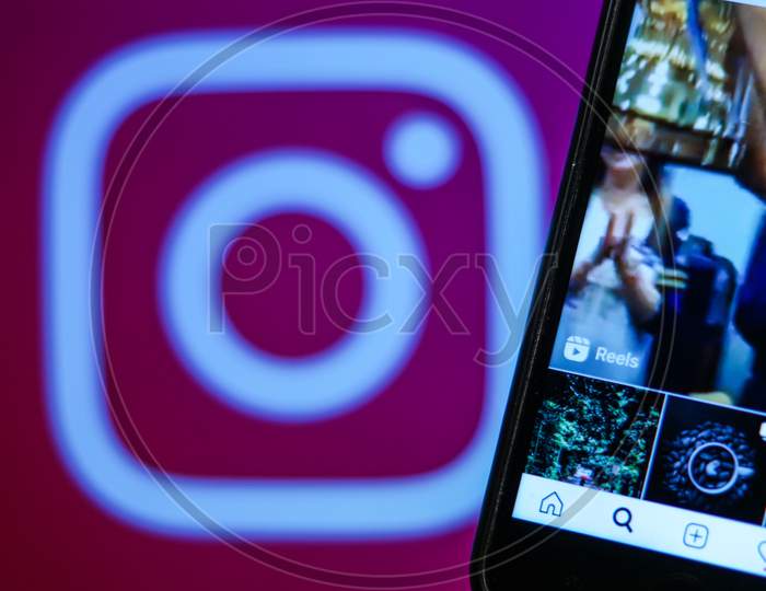 Instagram new update Instagram Reels Feed on a Mobile Screen with Instagram logo in the background
