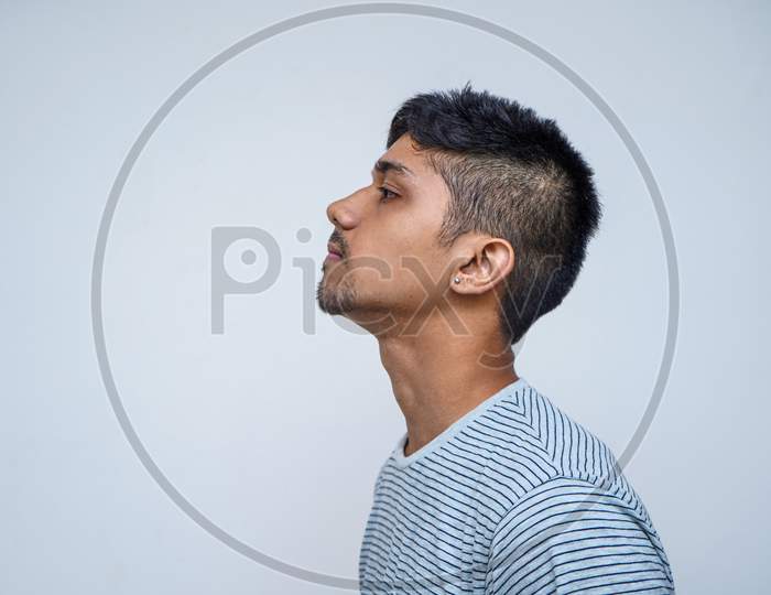Sensual And Thoughtful. Portrait Of Handsome Shirtless Young Indian Male Model Being Sensual And Thoughtful While Standing Against White Background.